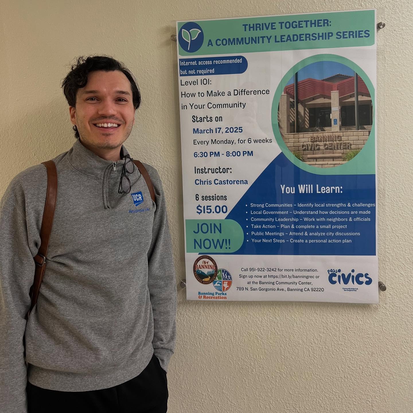 Chris Castorena III beside the 2025 Pass Civics class poster at the Banning Community Center